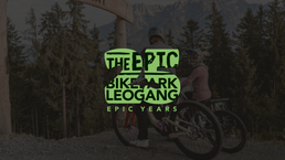 Mountainbiker:innen im Epic Bikepark Leogang vor alpiner Berg- und Waldkulisse mit „Epic Years“-Branding. | © Yvonne Hörl 